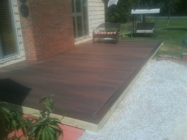 Freshly stained wood deck built against a brick home in Croydon
